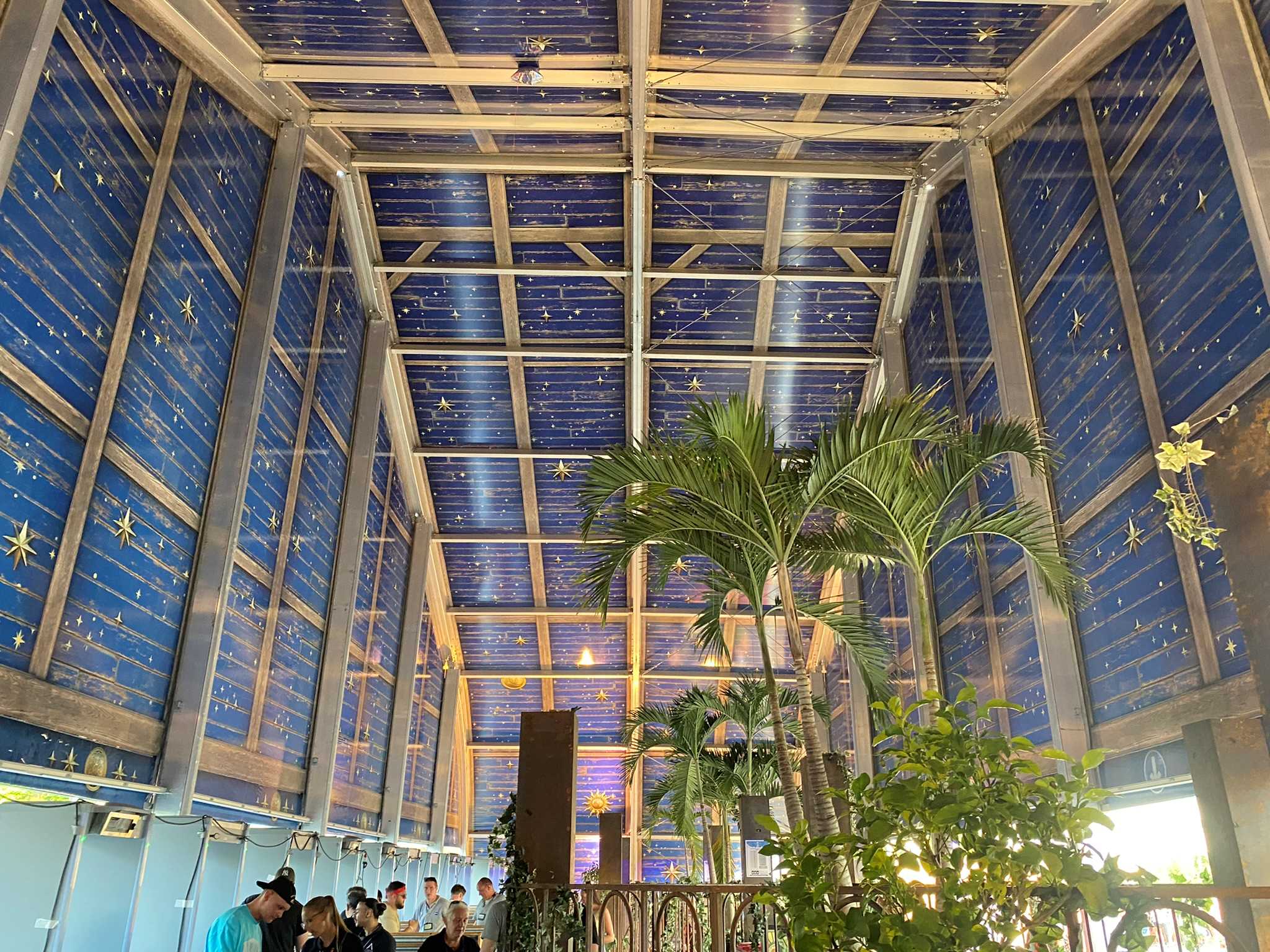 Tomorrowland tent interior with celestial-themed ceiling design and palm trees